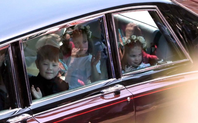 Prince Harry's niece and bridesmaid Princess Charlotte (R) arrives for the wedding ceremony of Britain's Prince Harry, Duke of Sussex and US actress Meghan Markle at St George's Chapel, Windsor Castle, in Windsor, on May 19, 2018. / AFP PHOTO / POOL / Andrew Matthews